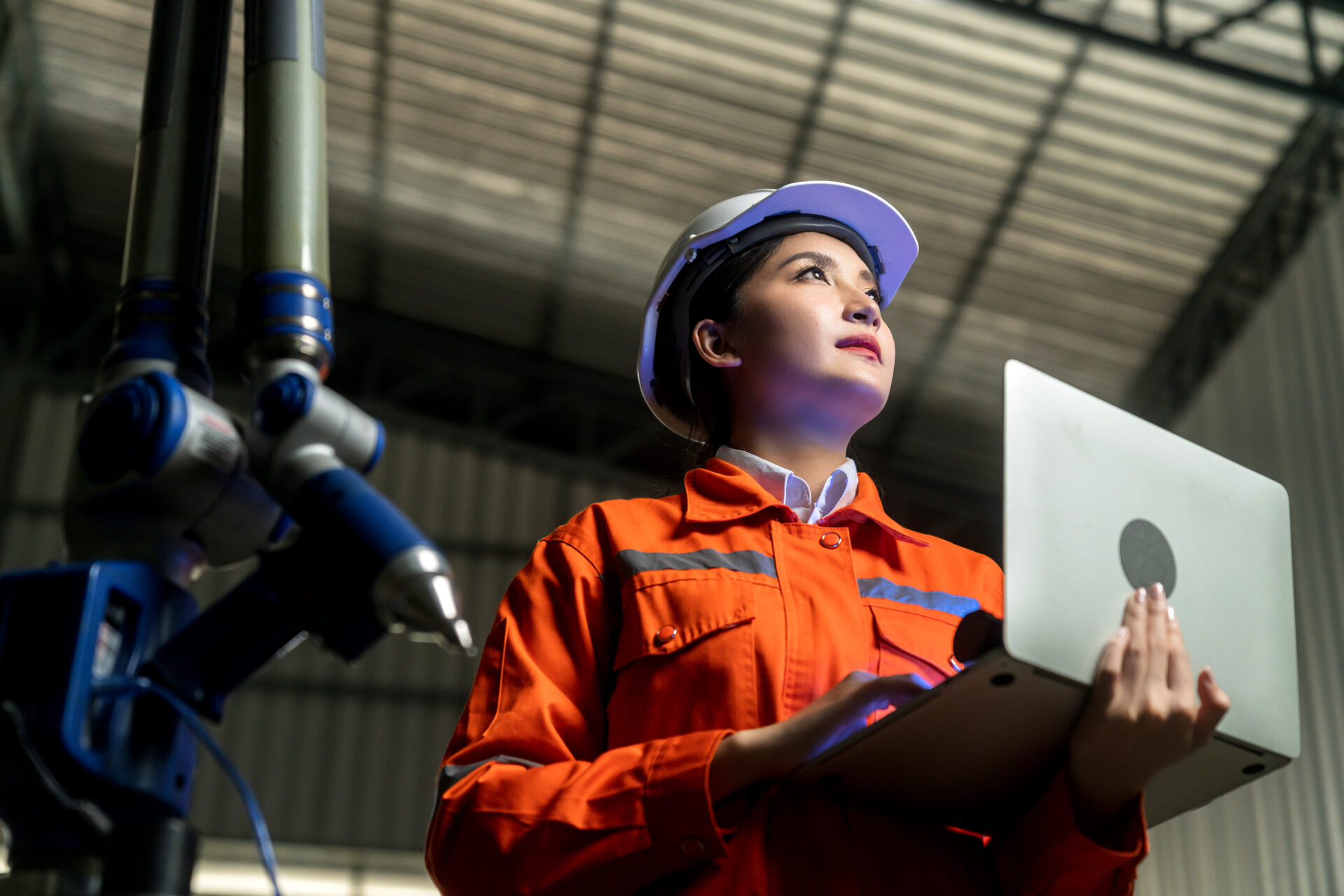 engineer specialist asian female and technician maintenance inspect relay robot arm system with laptop to control quality operate process work heavy industry 4.0 manufacturing smart factory